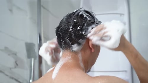 Man Using Shampoo in Shower