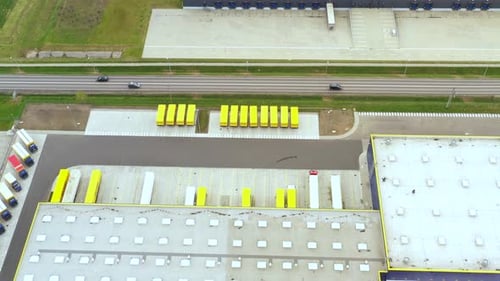 Aerial view. goods distribution warehouse. Semi trucks loading cargo containers. Logistics export an