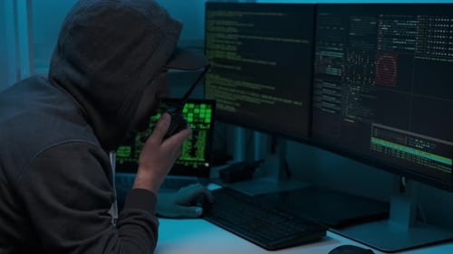 Computer hacker typing code on keyboard late night working and bypassing cyber security