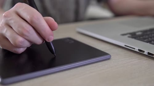 Artist using graphics tablet and stylus