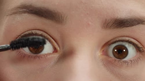 Woman Applying Mascara Extreme Close Up