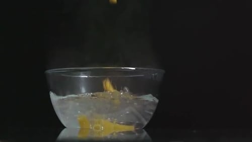 Pasta Falling Into Bowl of Hot Water