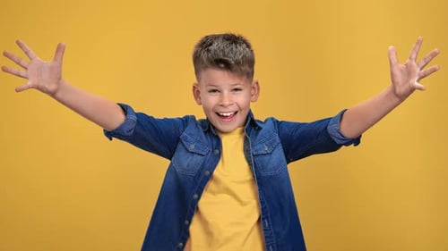 Happy Smiling Boy Waving on Yellow Background