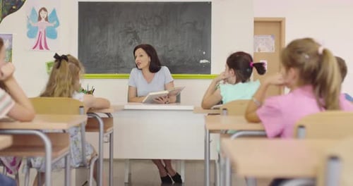 Elementary School Science Classroom Enthusiastic Teacher Explains Chemistry to Diverse Group of
