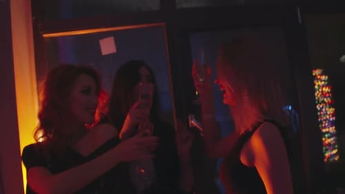 Three Young Women Celebrate at a Nightclub