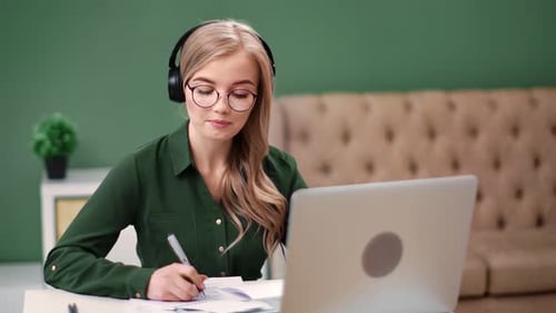 Woman Attends Online Meeting with Headphones
