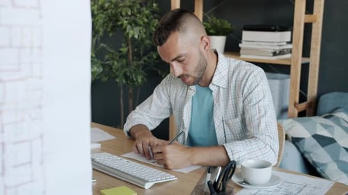 Slow Motion Portrait of Attractive Guy Architect Drawing Construction Plan Looking at Computer