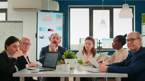 Multiethnical Team Talking with Remote Manager During Virtual Meeting