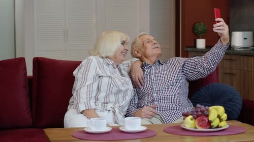 Happy Senior Couple Taking a Selfie at Home
