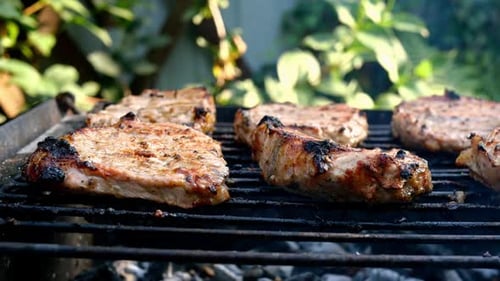 Frying Juicy Pieces of Fresh Pork Neck Steak Meat Prepared on Grill or Outdoor Barbecue Lattice