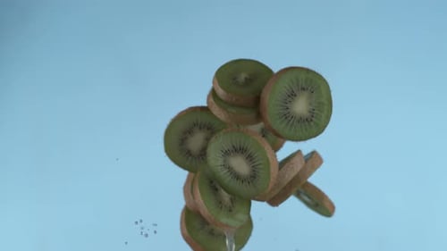 Sliced Kiwi Fruit Falling in Slow Motion