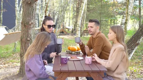 Happy Family on a Picnic in the Park at Autumn