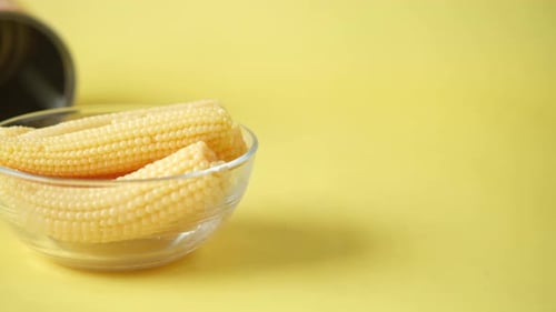 Sweet Baby Corn in Bowl on Yellow Background
