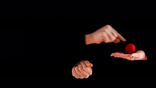 Magician Trick with Red Balls on Black Background