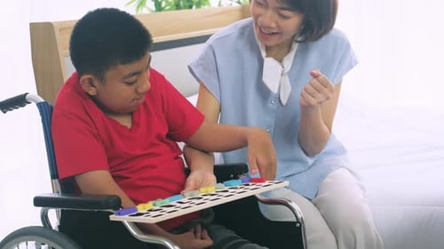 Boy in Wheelchair Learns Alphabet with Assistant