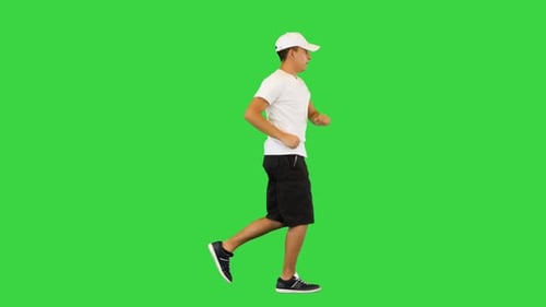 Young Man with Smart Watch Jogging on a Green Screen Chroma Key