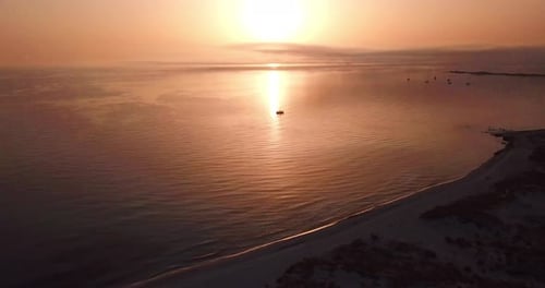Golden hours sunset over the ocean surface in drone aerial view landscape seascape with sun