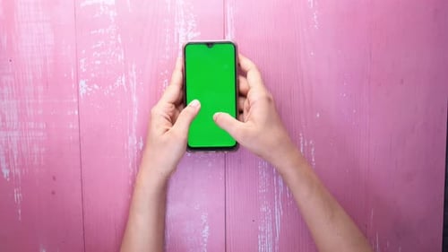 Top View of Women Hand Using Smart Phone with Green Screen