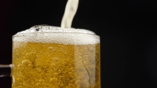 Beer Pouring Into Glass Mug
