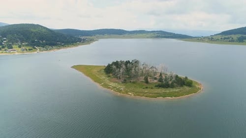 Beautiful small island in with clear lake waters in the summer