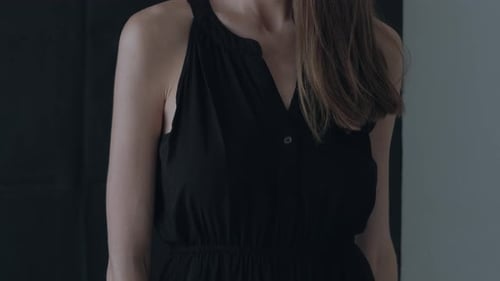 Woman Wearing Black Dress Posing Indoors