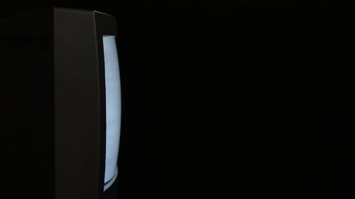 Vintage Television Displaying White Static in Dark Room