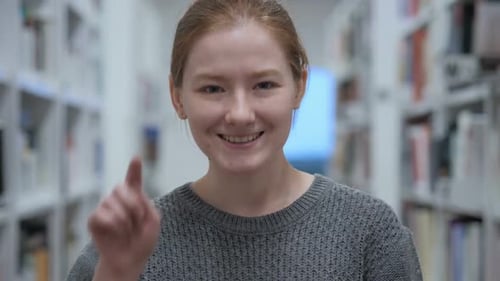 Positive Excited Woman Pointing at Camera in Cafe Thumbs Up