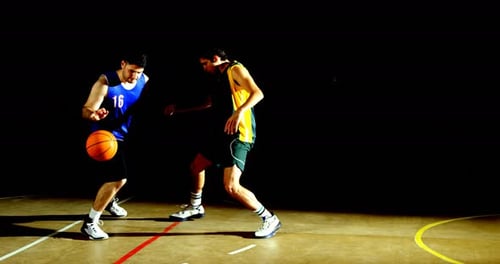 Competitors playing basketball in the court