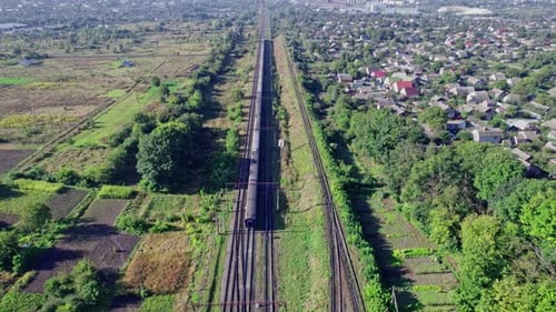 Aerial View of Train Traveling Through Green Landscape