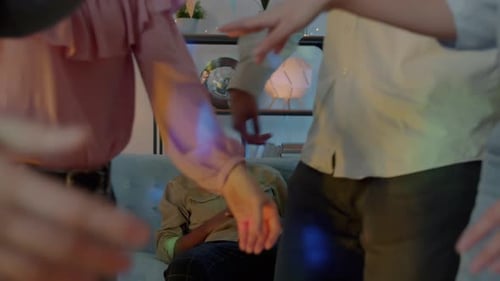 Zoomout of Tired Man Sleeping While Friends Diverse Group Dancing Enjoying Party at Home