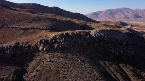 Landscape View of Mountain Valley with Stony Rolling Hills