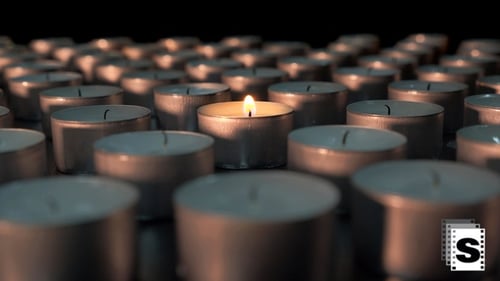 Multiple Candles Glowing Softly in the Dark