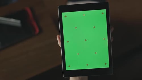 Female Hand Swiping Green Screen Tablet. Close Up Tablet with Chroma Key Screen