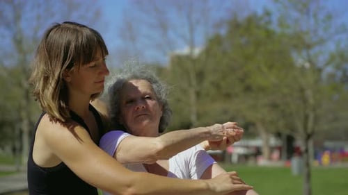 Personal Coach with Elderly Client in Summer Park