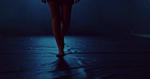 Athlete's Legs Go Through the Gym Dark Room