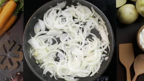 Sliced Onions Being Sauteed in Pan with Oil