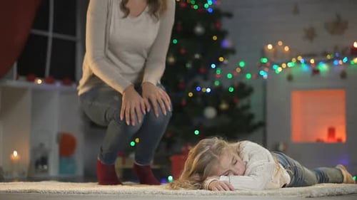 Loving Mother Embraces Sleeping Child on Christmas Eve