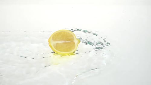 Lemon Wedge Splashes into Water