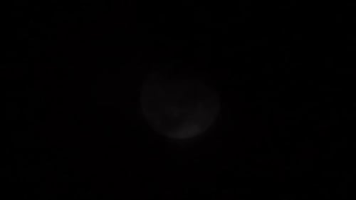 Dramatic Moon at Night with Passing Clouds