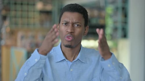 Agitated Young Man Gesturing Angrily, Close Up