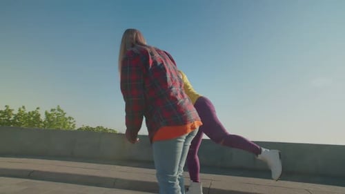 Friends Skateboarding Together on Sunny Day Outdoors