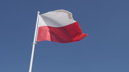 Flag of Poland Waving Against Blue Sky