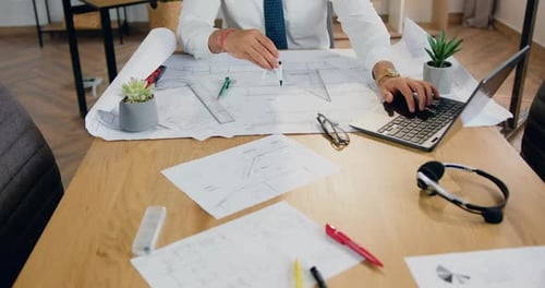 Architect which Thinking Over Paper Project, He Hand Sketching with Compass in Modern Design Office