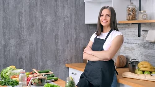 Smiling Woman in Kitchen with Fresh Food