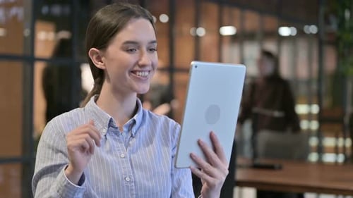Young Woman Having Video Call on Tablet in Office