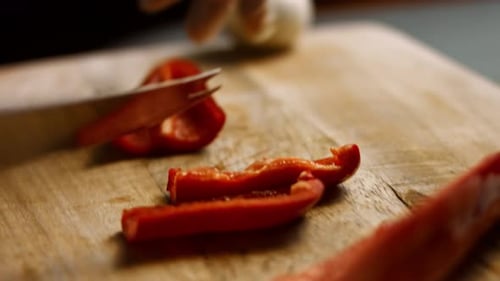Slicing a Red Bell Pepper on Cutting Board