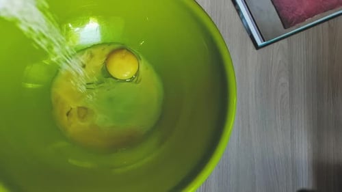 Granulated Sugar Added To Raw Eggs in Bowl