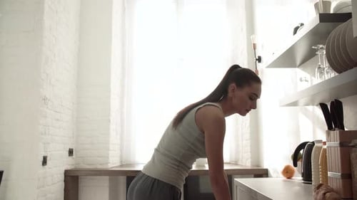Woman Preparing Food in Bright Modern Kitchen