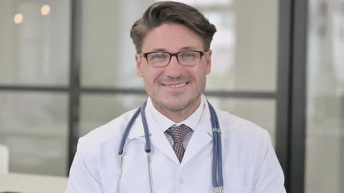 Smiling Doctor in White Coat at the Hospital