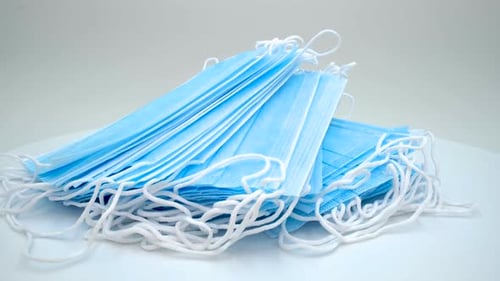 Stack of New Light Blue Surgical Face Masks